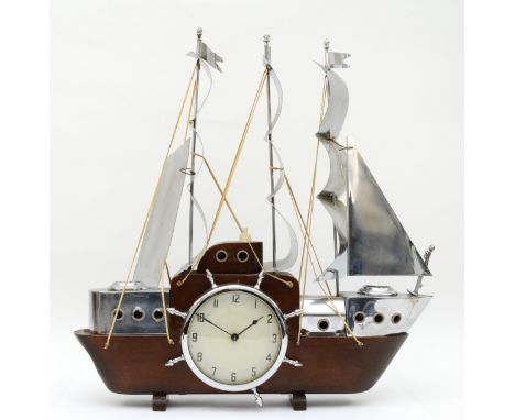 A mid 20th century mahogany and chrome plated mantle clock modelled in the form of a three mast sailing boat, the 'ships whee