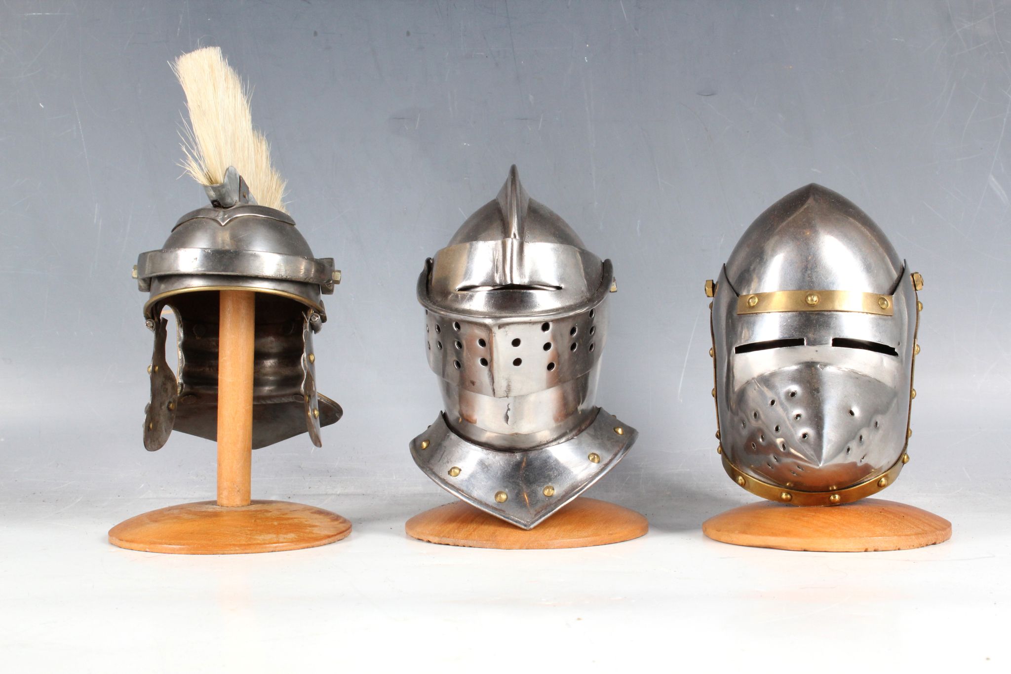 Three miniature desk top helmet ornaments; plumed Roman helmet and two ...