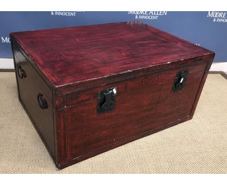 A modern Chinese red lacquered trunk with metal lock plates and side carrying handles 92 cm wide x 68 cm deep x 45 cm high (t