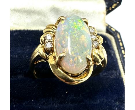 18ct gold large opal &amp; diamond ring opal measures approx 16mm by 8mm with 3 diamons each side weight 6.3g 