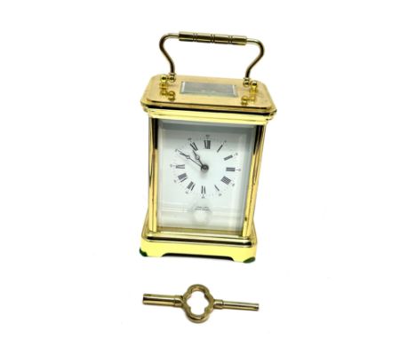 Large striking brass carriage clock measures approx  14cm high comes with key the clock is ticking strikes on hour &amp; half