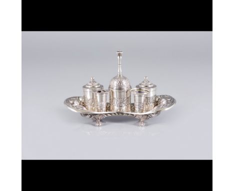 A writing setSilver 833/000Comprising of inkwell, sand pot, a container, two quill holders and bellFloral decorationResting o