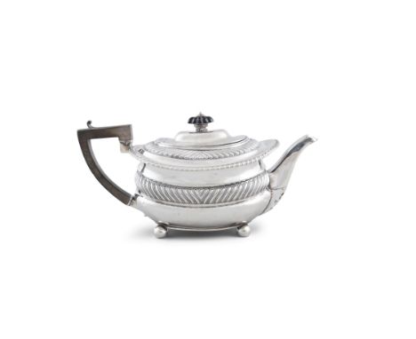 A GEORGE III SILVER TEA POT, London c.1812 marks rubbed, of shaped rectangular form with bright cut engraved banding, raised 