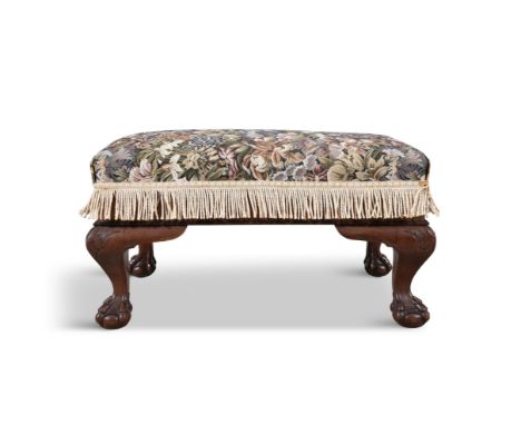 AN UPHOLSTERED MAHOGANY FRAMED STOOL,c. 1930, of rectangular shape, covered in a floral tapestry fabric, on cabriole legs and