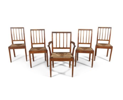 A SET OF FIVE ENGLISH OAK FRAMED STICK BACK DINING CHAIRS WITH DROP-IN RUSH SEATS,attributed to Alan 'Acornman' Grainger in t