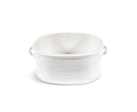 A WHITE PORCELAIN OVAL BASIN, of plain form with applied carrying handles. 57cm wide over handles