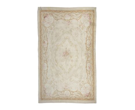 A LARGE AUBUSSON TAPESTRY CARPET. 374 x 242CMthe cream ground field woven with central floral medallion and flower groups to 
