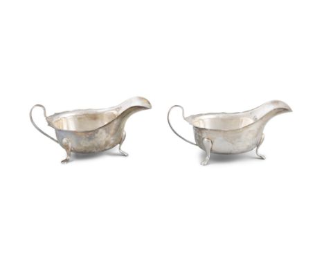TWO SILVER SAUCEBOATSthe scalloped rim and cabriole feet with maker's mark London Sheffield, (6.31 troy ozs). 15.5 x 6.5cm hi