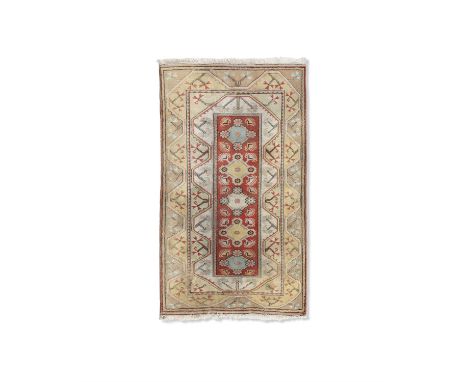 A TURKISH CREAM GROUND WOOL CARPET, 207 X 120CM the rectangular centre field woven with five lozenges within a narrow serrate