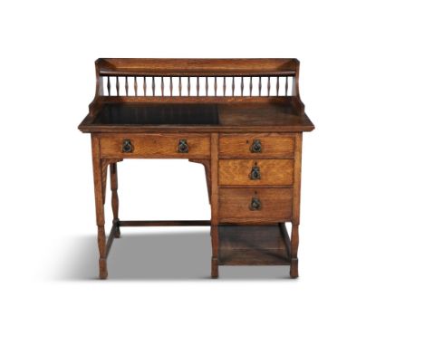 AN ARTS & CRAFTS STAINED OAK DESK ATTRIBUTED TO SHAPLAND & PETTER OF BARNSTABLE,with raised shelf on a galleried frieze, a gi