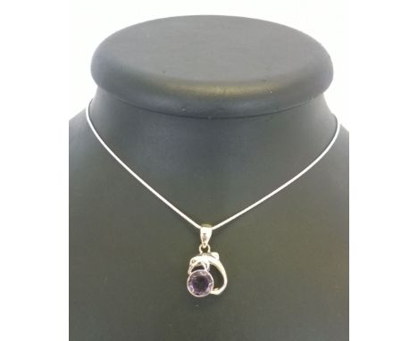 A 925 silver pendant of a dolphin set with a Amethyst on a rope chain