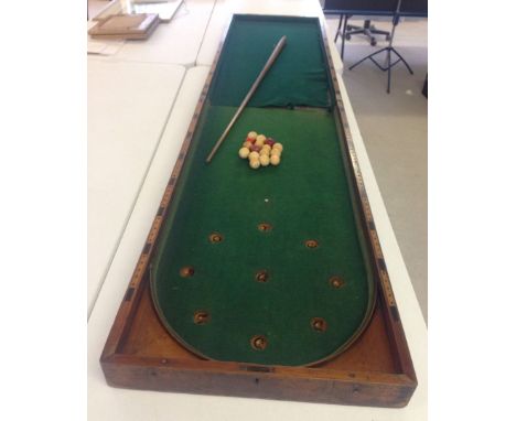 A Victorian folding billiard style bagatelle table with 15 ivory balls and cue. One half of baize has been replaced and a/f