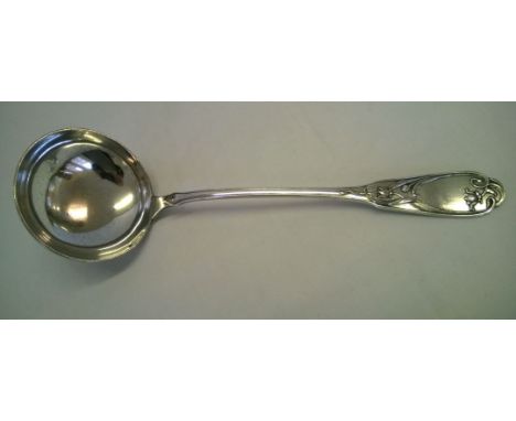 An Art Nouveau ladle in white metal possibly, continental silver.  Weight approx 235g.