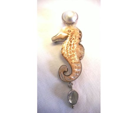 A mother of pearl carved sea horse design brooch/pendant with white topaz and Mabe pearl encased in 925 silver