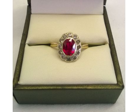 Hallmarked 9ct gold ladies ring with central 0.75ct oval ruby surrounded by clear stones.  Size M, total weight approx 3.1g
