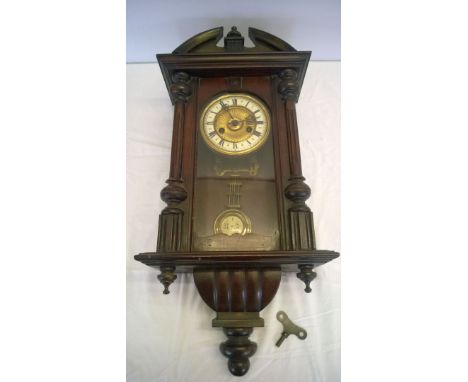 A Victorian carved wooden cased wall clock, gilt face and enamel dial.