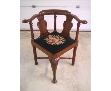 A Victorian corner chair with swept back and black & flowered tapestry seat.