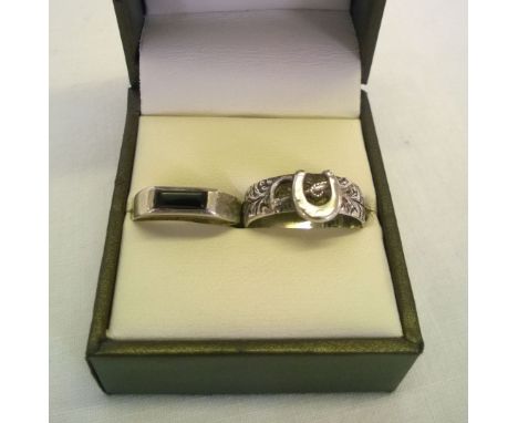 2 silver rings, one is a band featuring a horseshoe & riding crop (size P) and the other is set with a black onyx stone (size