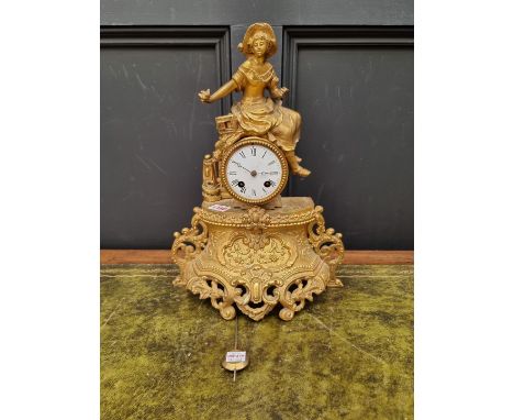 A gilt spelter mantel clock, 40cm high, with pendulum.&nbsp; 