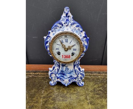 An antique French faience mantel clock, by Maple &amp; Co Ltd, Paris, 26cm high, with pendulum.&nbsp; 