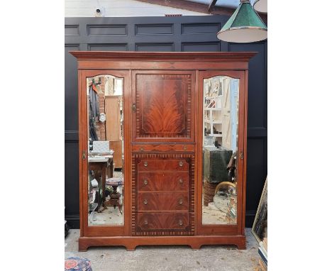 An Edwardian mahogany and inlaid bedroom suite,&nbsp;comprising: a triple wardrobe, 200.5cm wide; a mirror back dressing tabl