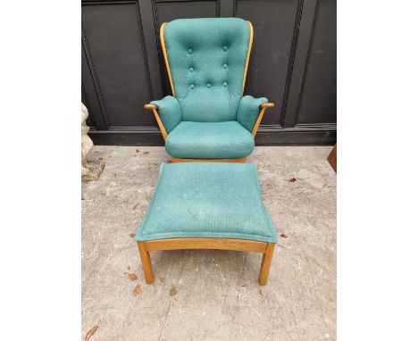 An Ercol 'Evergreen' armchair; together with an Ercol 'Saville' elm stool.&nbsp; 