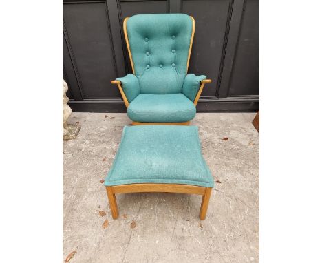 An Ercol 'Evergreen' armchair; together with an Ercol 'Saville' elm stool.&nbsp; 