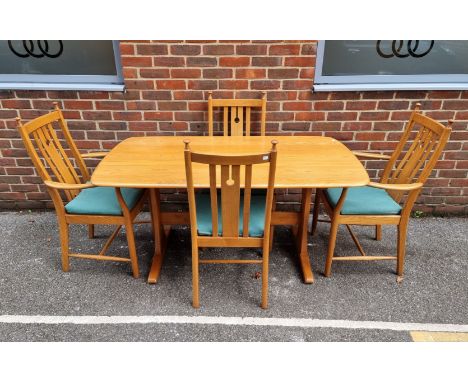 An Ercol elm dining table and four chairs, to include a pair of elbow chairs, the table 152.5cm long. 