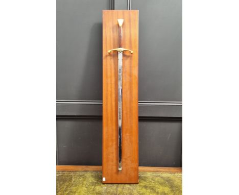 A modern twin handled broadsword, by Wilkinson, total length 108cm, on wall mounted display stand.&nbsp; 