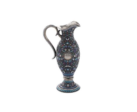 A late 19th century Russian silver and cloisonné enamel small jug of vase form with a shaped rim, scroll handle and flaring c