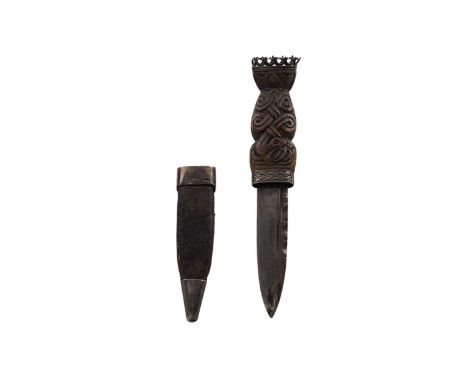 A late Victorian Scottish provincial silver-mounted skien-dhu, with a carved wooden hilt and leather scabbard with engraved m