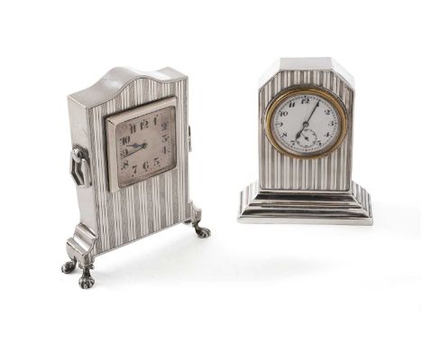 An art deco silver mounted timepiece, with engine-turned decoration, an arched top, four paw feet and two drop handles, the s