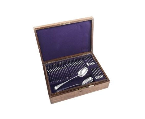 A collected service of Old English pattern flatware in a lined and fitted oak canteen box to include: a set of twelve tablesp