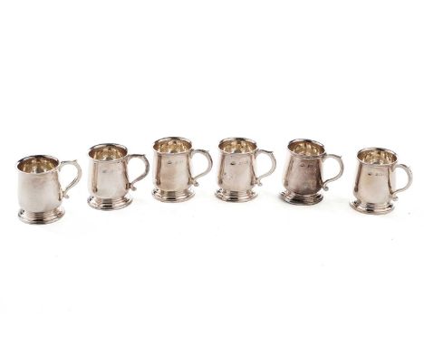 A set of six George V silver tot cups, in the form of miniature mugs, by Adie Brothers LTD, Birmingham 1925, 4cms high - 5.65