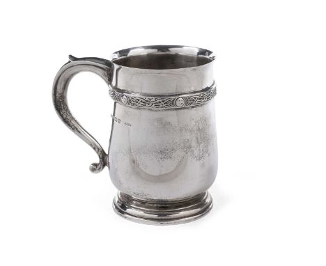 A George VI silver mug with a tucked-in base and applied border of ‘Celtic’ knotwork with bosses below the rim, by Elkington 