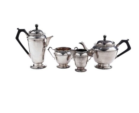 A George V silver four-piece tea service, art deco in style with applied ‘Celtic’ borders around the rims and bases, angular 