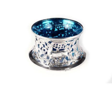A George V Irish silver dish ring, in the rococo manner, pierced and embossed around the sides with a stag, a hind, and two h