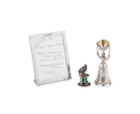 A miniature silver wager cup in the form of a lady in a crinoline dress holding aloft a swivel cup, with pseudo marks; a cast