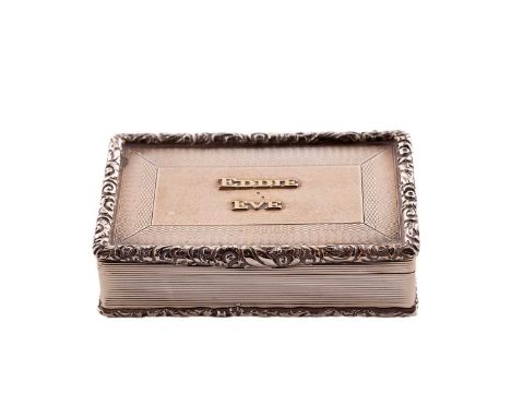 A George V silver snuff box, rectangular with raised floral scroll borders, reeded sides and engine turning, the cover with t