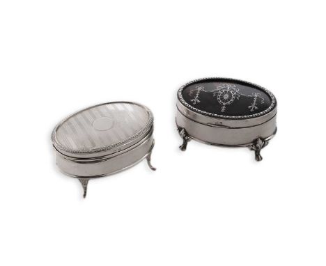 An Edwardian silver mounted and inlaid tortoiseshell jewel box of oval outline, on four leafy paw feet, lined interior, by Ma