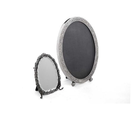 A 20th century North American silver photograph frame, oval with etched decoration, two ball feet and a fabric covered easel 