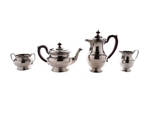 A World War II period silver four-piece tea set with circular bodies, spreading circular bases and borders of repeating flore