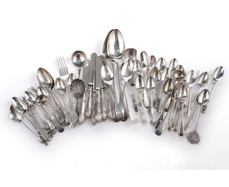 A mixed lot: a quantity of assorted silver tea and other small spoons; three pairs of silver sugar tongs; three small silver 
