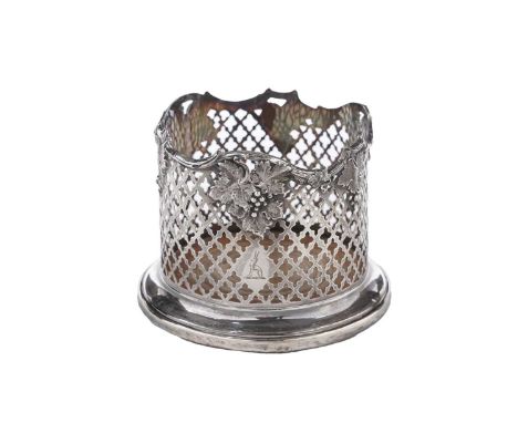 A Victorian silver coaster with pierced trellis-work sides, applied vines around the rim and an inset, turned wooden base, cr