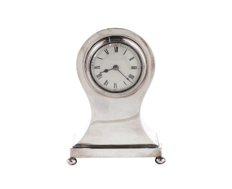 An early George V silver timepiece, balloon-shaped with a rectangular base and button feet, the cream-coloured dial with blac
