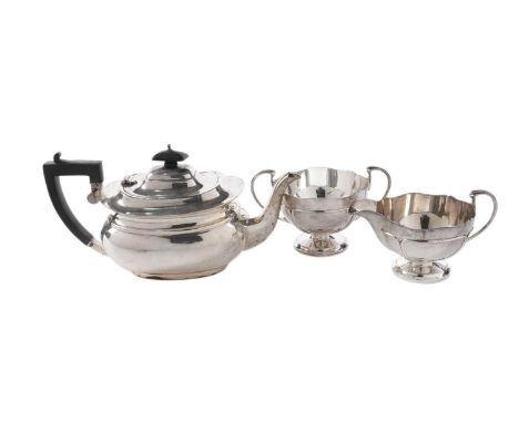 A George V silver teapot of plain rounded oblong form, with a bellied body, by James Carr, Birmingham 1932; together with a s