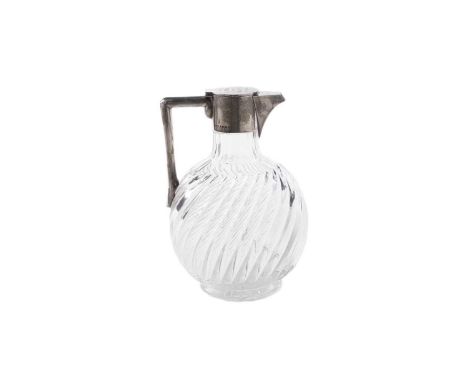 A Victorian silver mounted clear glass claret jug, with a wrythen-fluted, flask-shaped body and angular handle, and a plain m