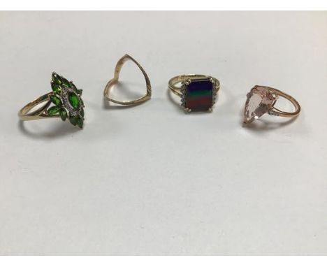 A collection of four 9ct gold rings, one with marquise pale pink stone in claw setting, another set rainbow coloured stone mo