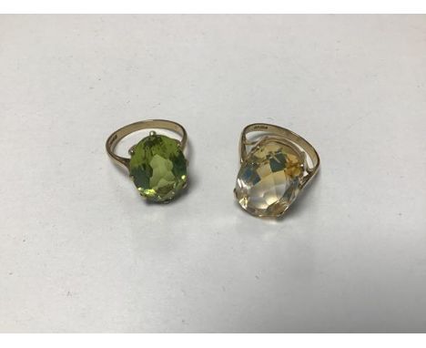 A 9ct gold dress ring set oval citrine in claw setting and a 9ct gold peridot set ring (P) (9.7g) (2)