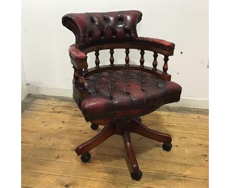 A reproduction leather and turned wood desk chair by Centurion Furniture, the hoop shaped frame with turned spindles and butt